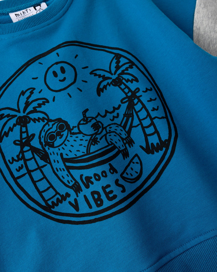 Close up of the Chill Sloth Short Sleeve Crew print in teal, orange and grey marle