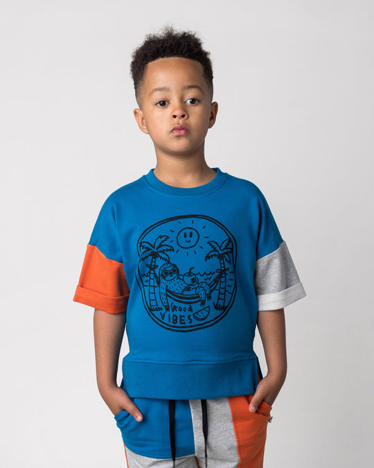 Close up of the Chill Sloth Short Sleeve Crew in teal, orange and grey marle on a kid, front view