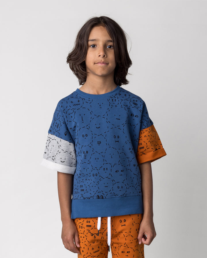 Close up of the Different Faces Short Sleeve Crew in navy, grey marle and orange on a kid, front view