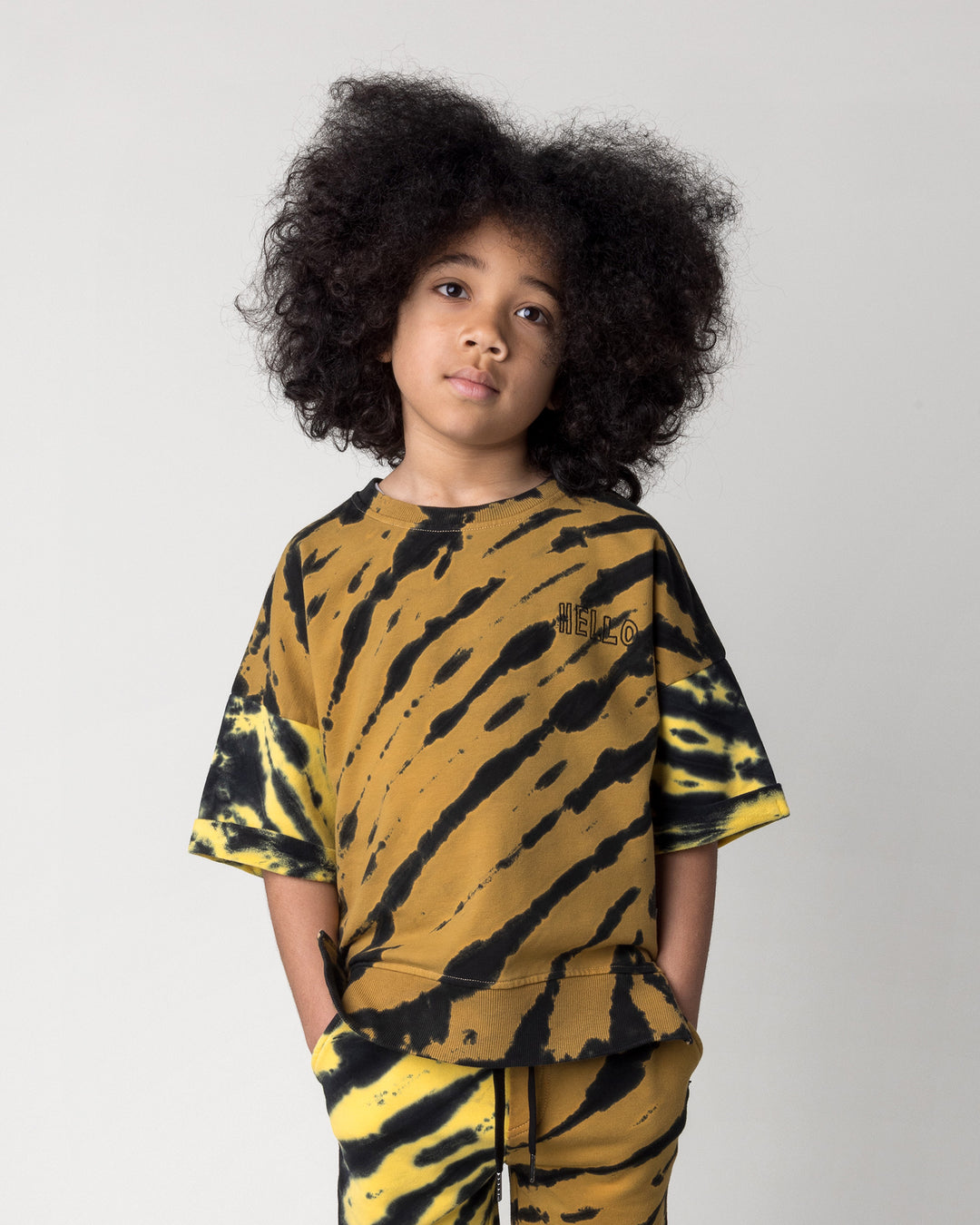 Close up of the Duo Tie Dye Short Sleeve Crew in lemon and rust on a kid, front view