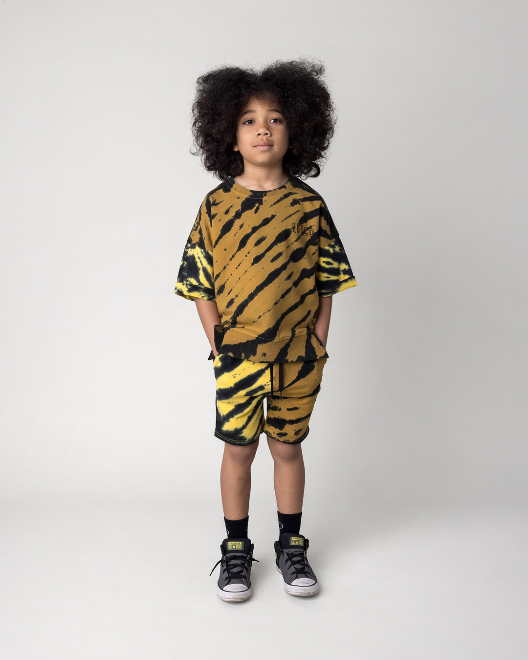 Kid wearing the Duo Tie Dye Short Sleeve Crew in lemon and rust with the Duo Tie Dye Short in lemon and rust, front view