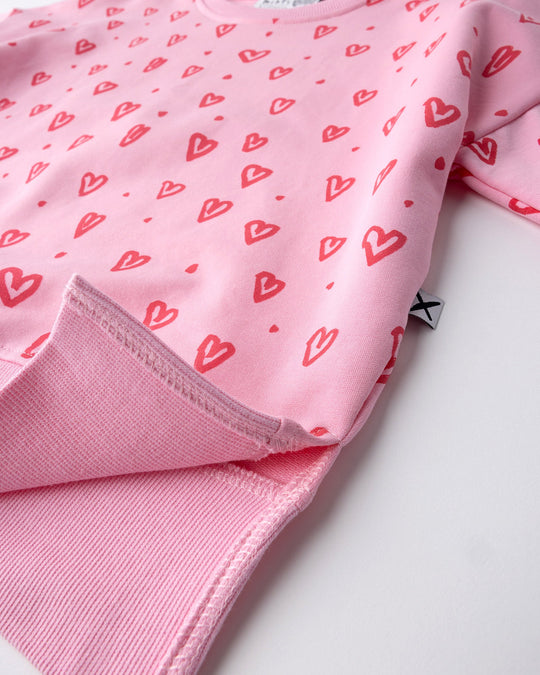 Close up of the Hearts Short Sleeve Crew print in pink