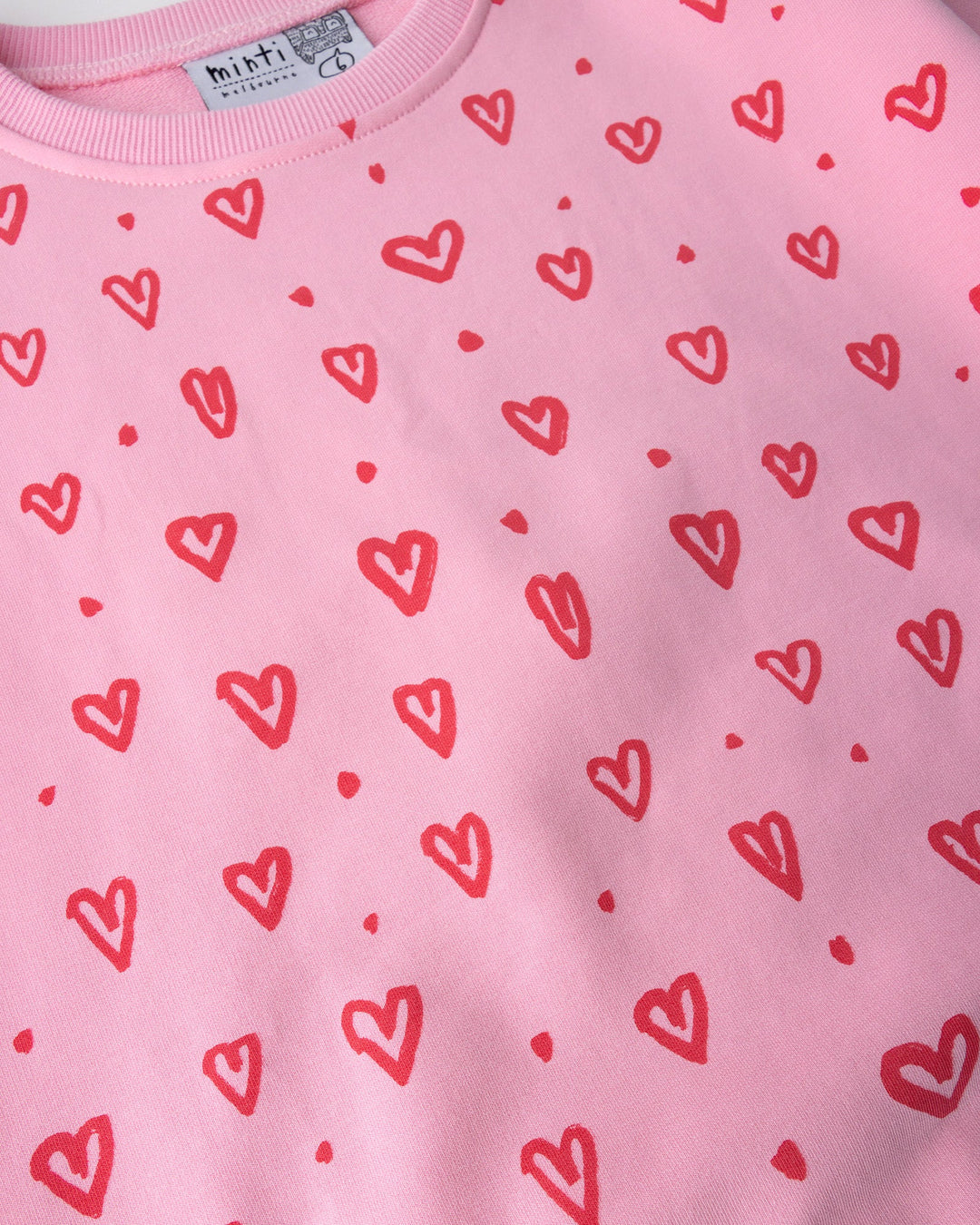 Close up of the Hearts Short Sleeve Crew print in pink