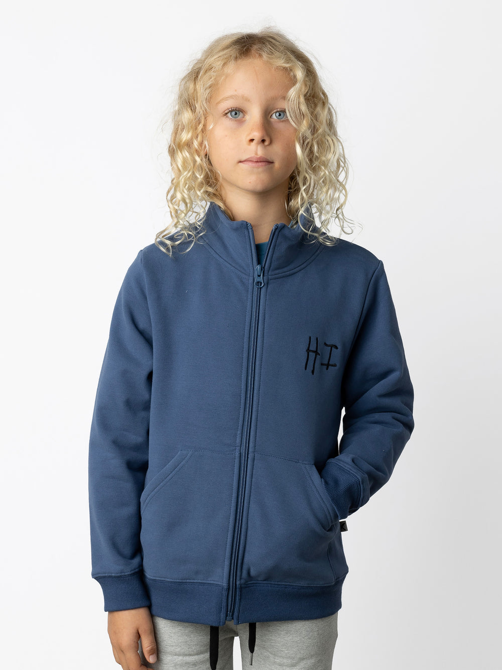 Minti kids clothing. Super cosy and soft zip up high neck crew with 2x2 Rib cuffs and hem. Front kangaroo pocket to keep hands warm. 330 Gram // Brushed Inside // 95% Cotton // 5% Elastane.