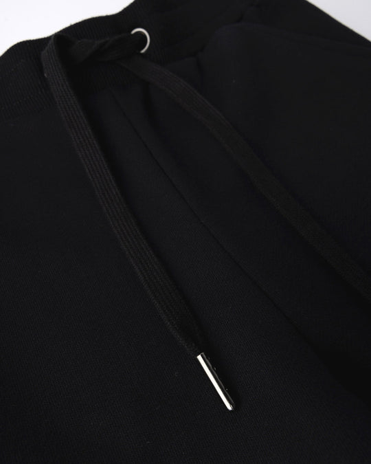 Close up detail of the Studio Trackies in black
