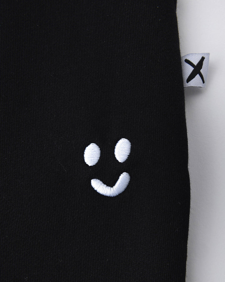 Close up detail of the Studio Trackies in black
