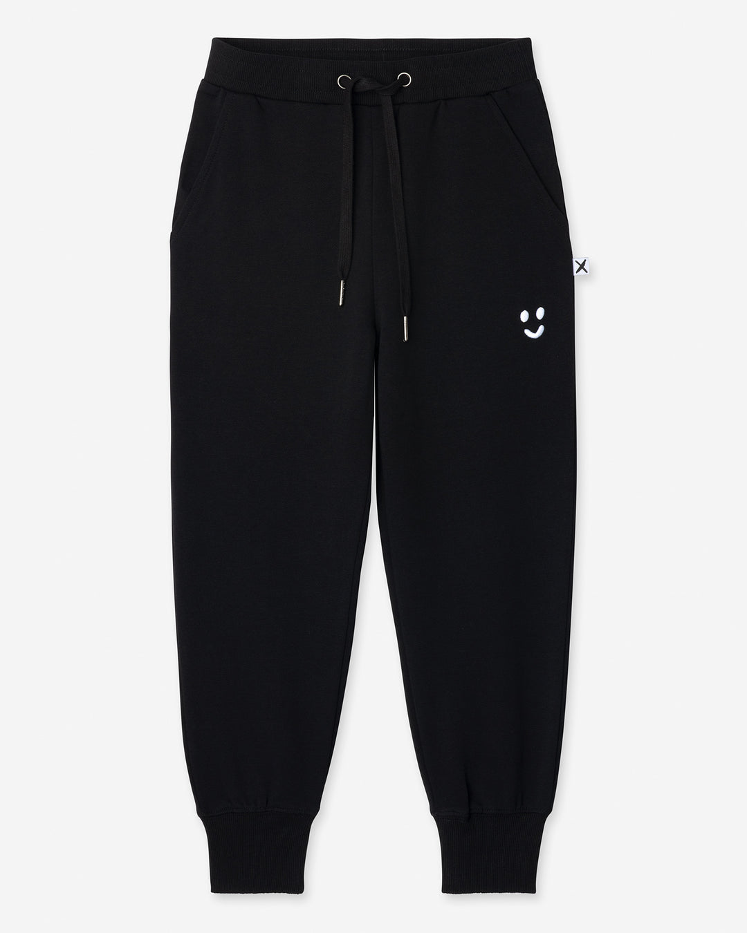 Studio Trackies in black, boys track pants by Minti, flat lay