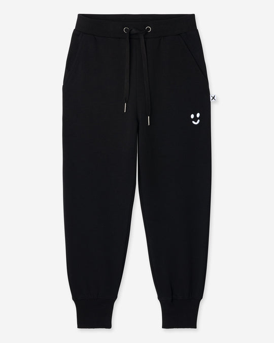 Studio Trackies in black, boys track pants by Minti, flat lay