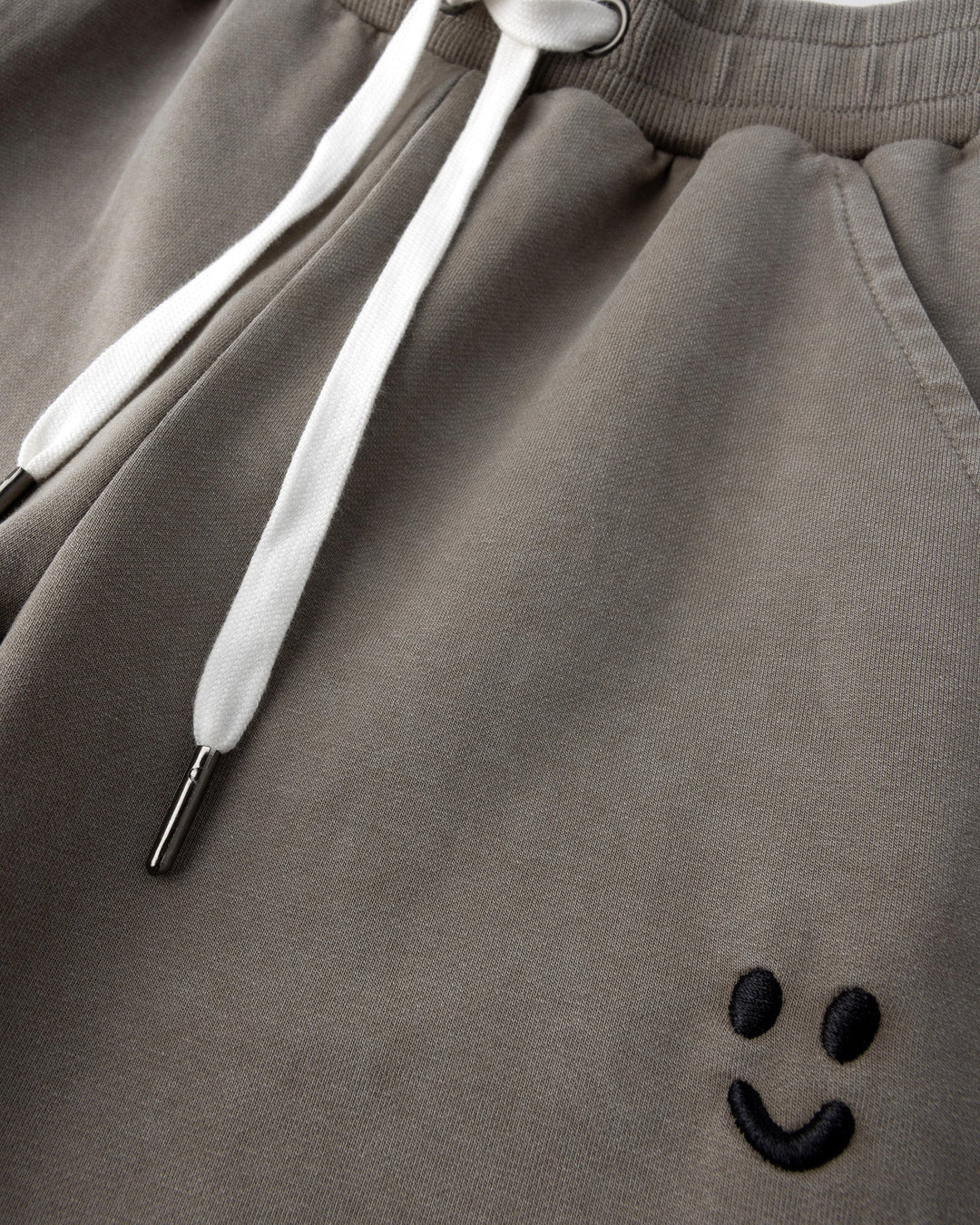 Close up detail of the Blasted Studio Trackies in grey wash