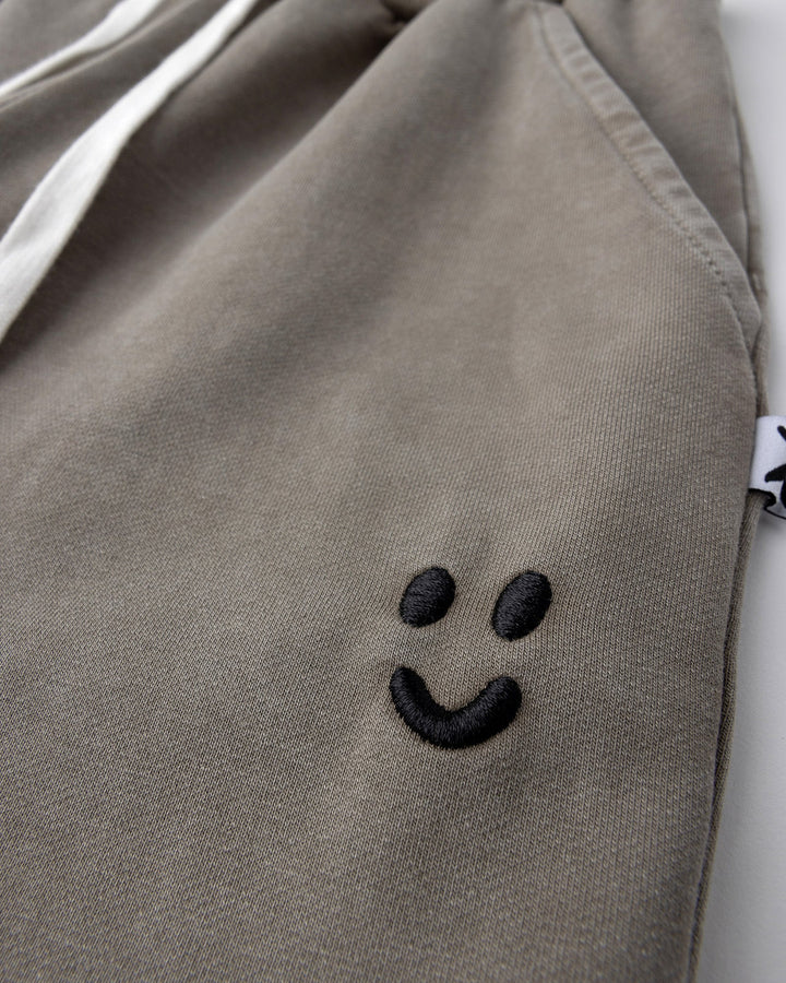 Close up detail of the Blasted Studio Trackies in grey wash