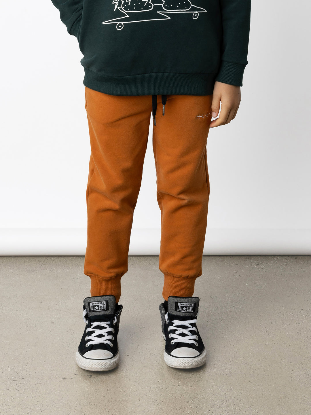 Minti kids clothing. Straight leg trackies with rounded front pockets, elastic waistband, shoelace ties, 2x2 rib cuffs and a small embroidery on the front. 330 Gram // Brushed Inside // 95% Cotton // 5% Elastane.