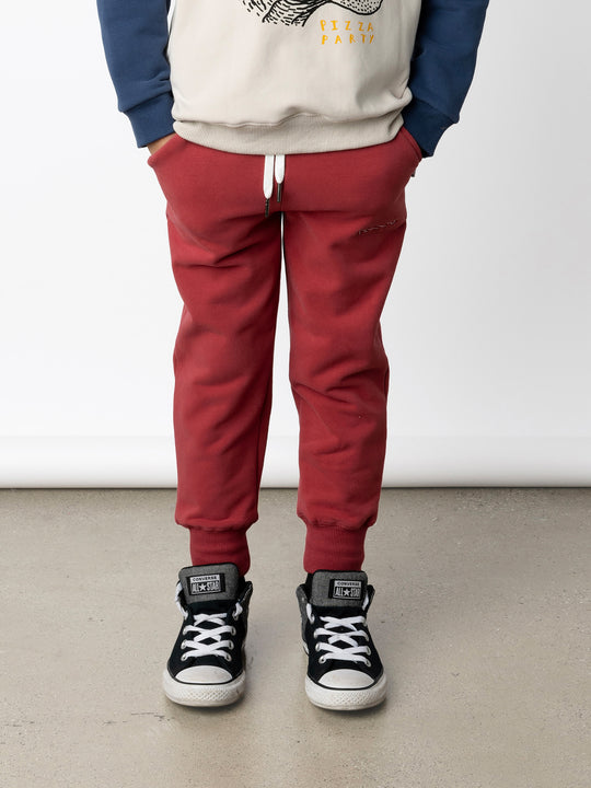 Minti kids clothing. Straight leg trackies with rounded front pockets, elastic waistband, shoelace ties, 2x2 rib cuffs and a small embroidery on the front. 330 Gram // Brushed Inside // 95% Cotton // 5% Elastane.