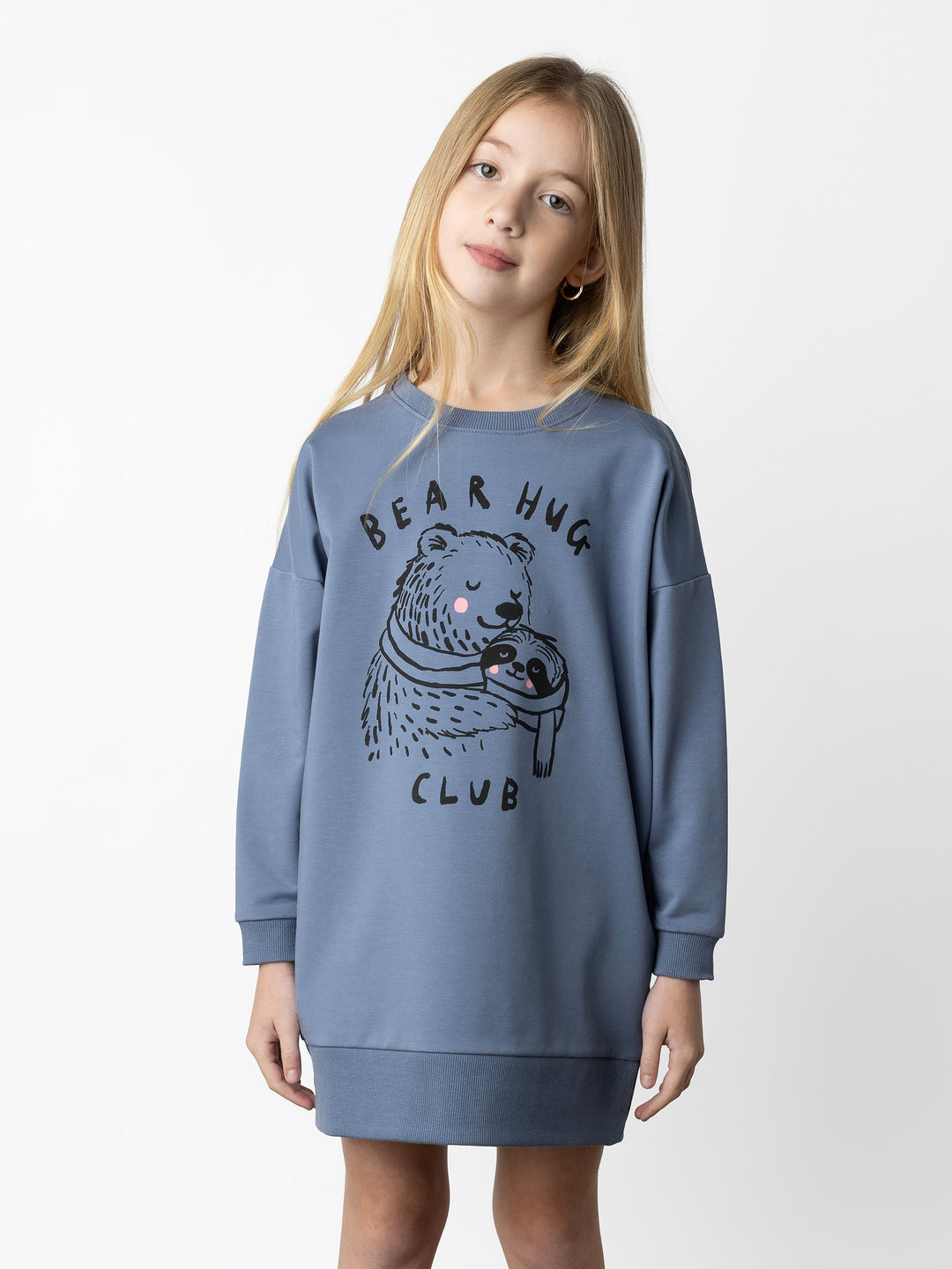 Minti kids clothing. Super cosy sweatshirting weight dress with drop shoulder detail. 2x2 Rib at the neck, hem and cuffs. Hidden side pockets. 320 Gram // 95% Cotton // 5% Elastane.