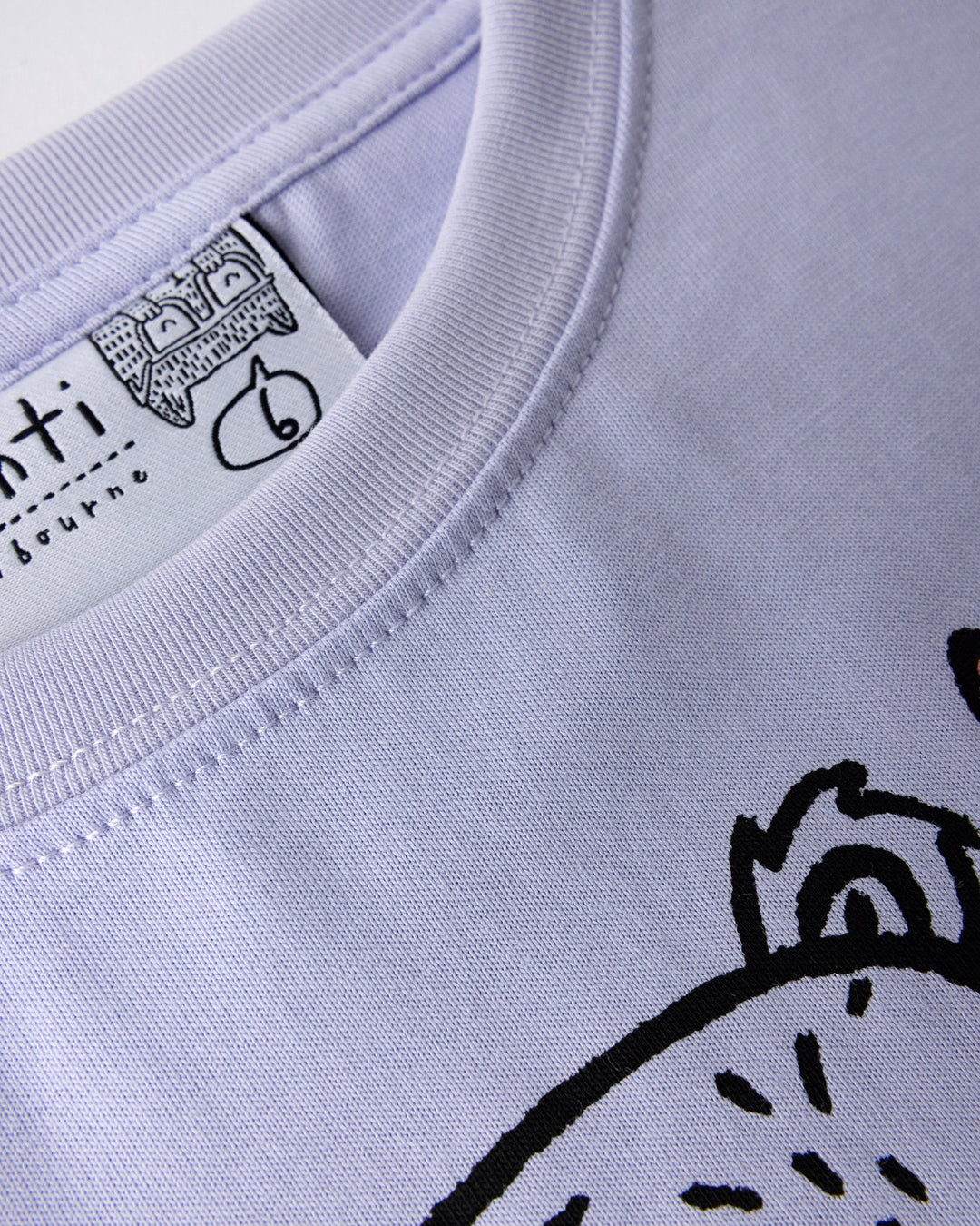 Close up detail of the Bear Hug Tee in lilac, lemon and blue