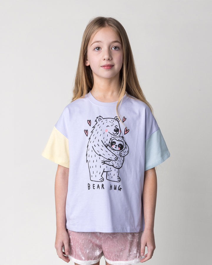 Close up of the Bear Hug Tee in lilac, lemon and blue on a kid, front view