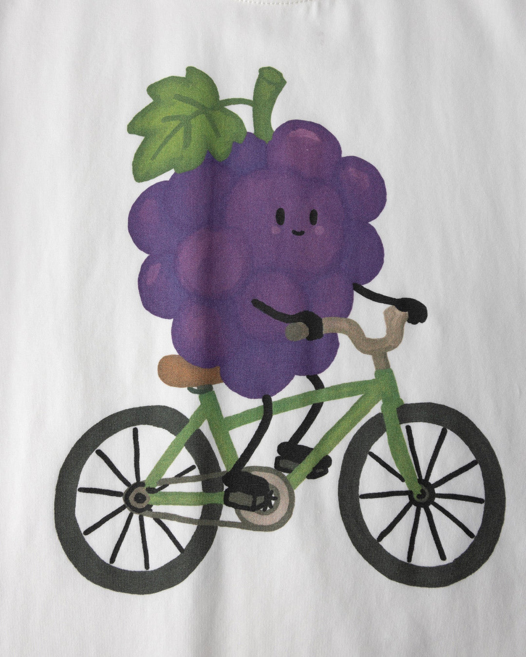 Close up of the Biking Grape Tee print in white, purple and green