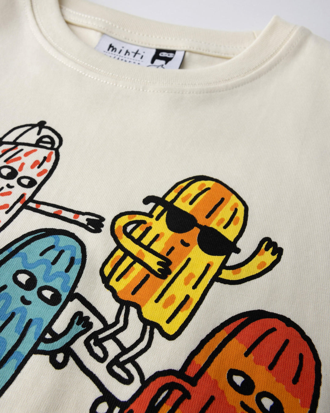 Close up of the Cool Crew Tee print in cream