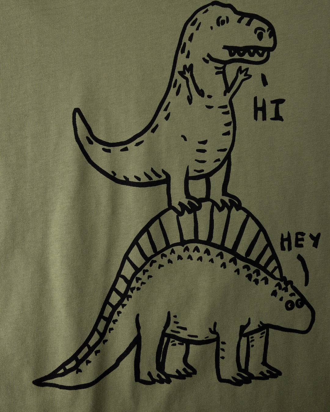Close up of the Dino Ride Tee print in light khaki