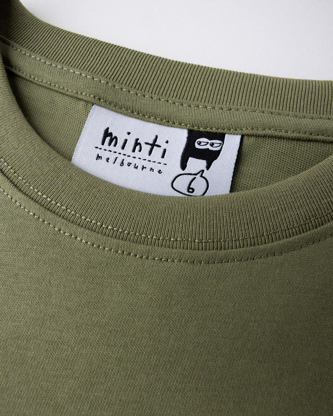Close up detail of the Dino Ride Tee in light khaki