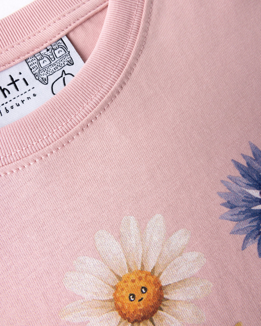 Close up of the Flower Friends Tee print in muted pink