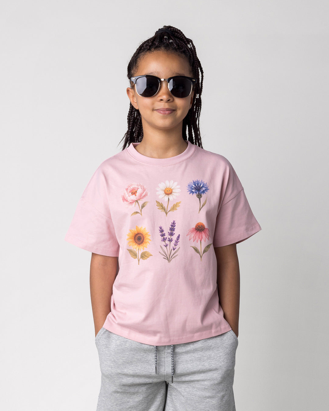 Close up of the Flower Friends Tee in muted pink on a kid, front view