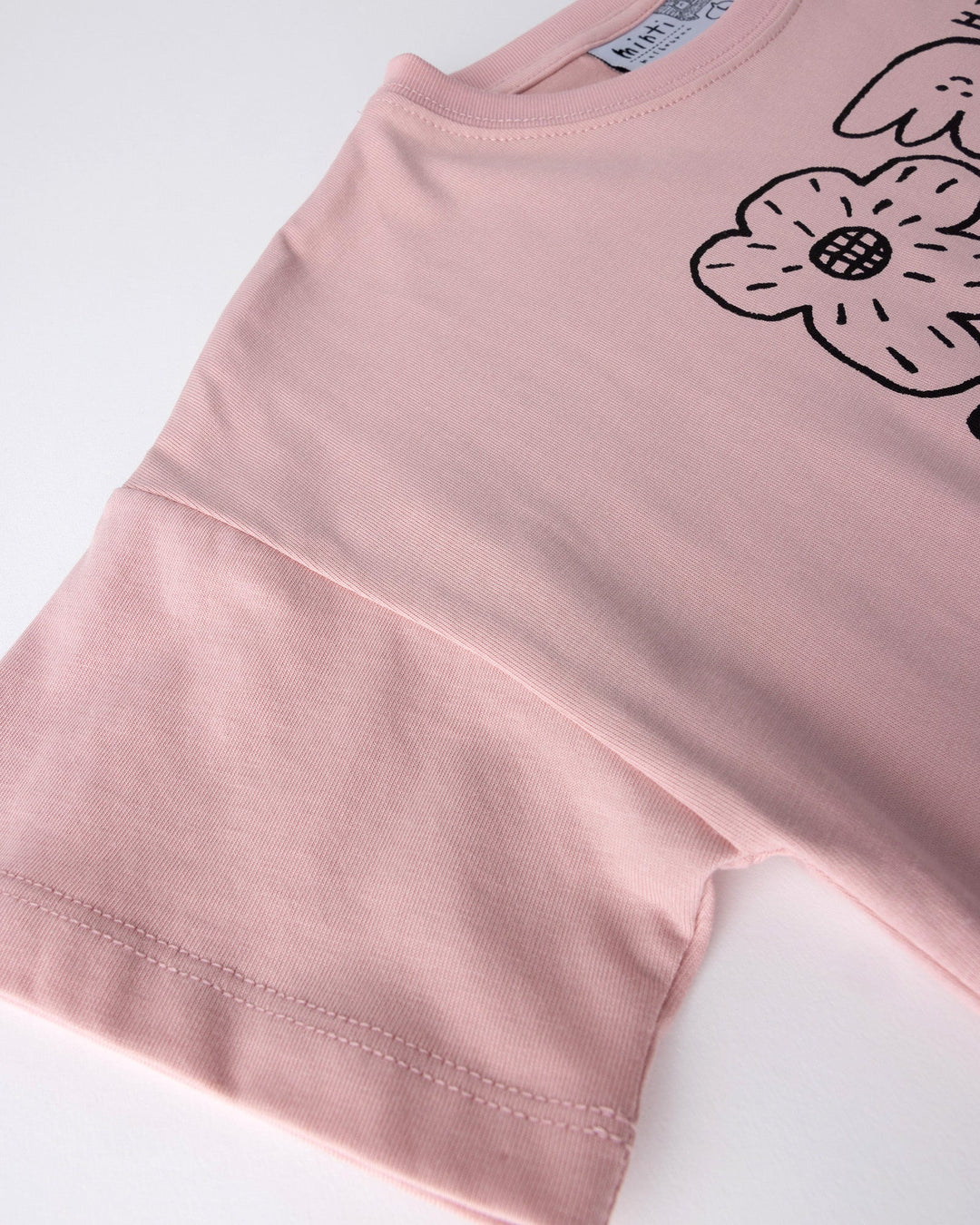 Close up detail of the Flower Party Tee in muted pink