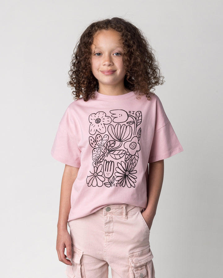 Close up of the Flower Party Tee in muted pink on a kid, front view