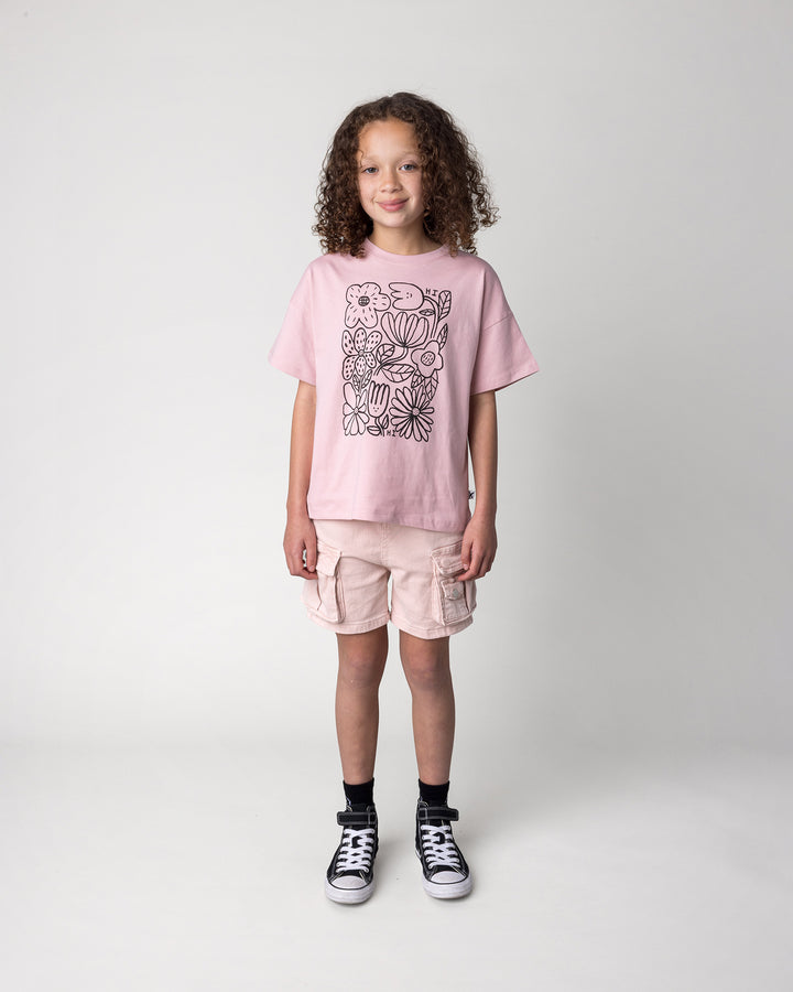 Kid wearing the Flower Party Tee in muted pink, front view