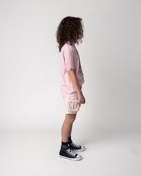 Kid wearing the Flower Party Tee in muted pink, side view
