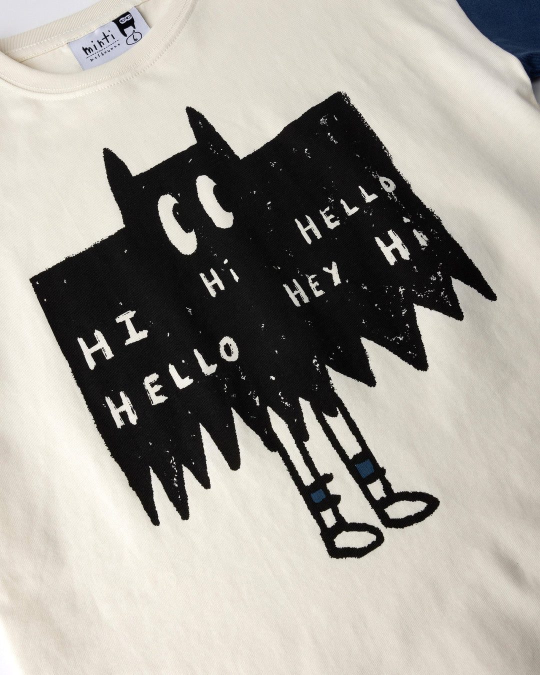 Close up of the Greetings Bat Tee print in cream, black and midnight