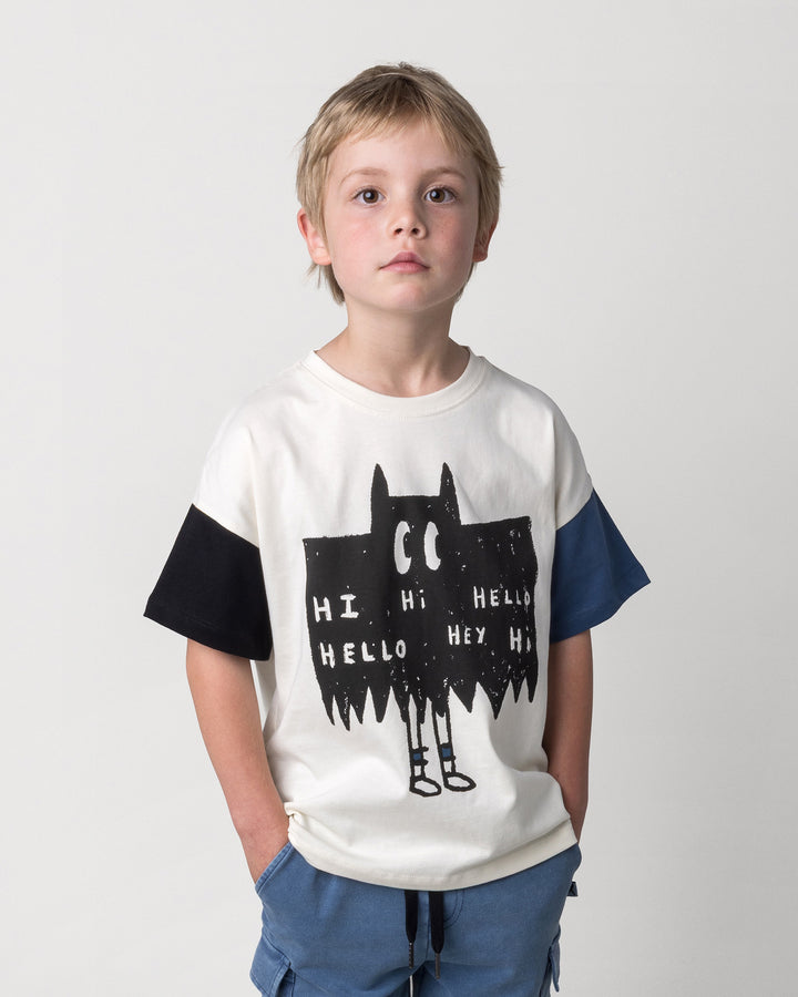 Close up of the Greetings Bat Tee in cream, black and midnight on a kid, front view