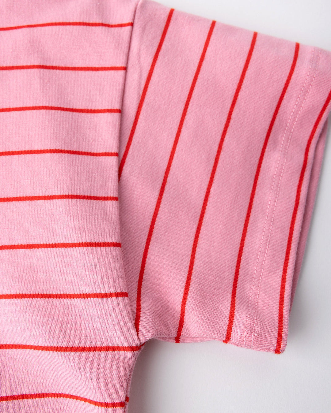 Close up detail of the Happy Rainbow Tee in pink and red stripe