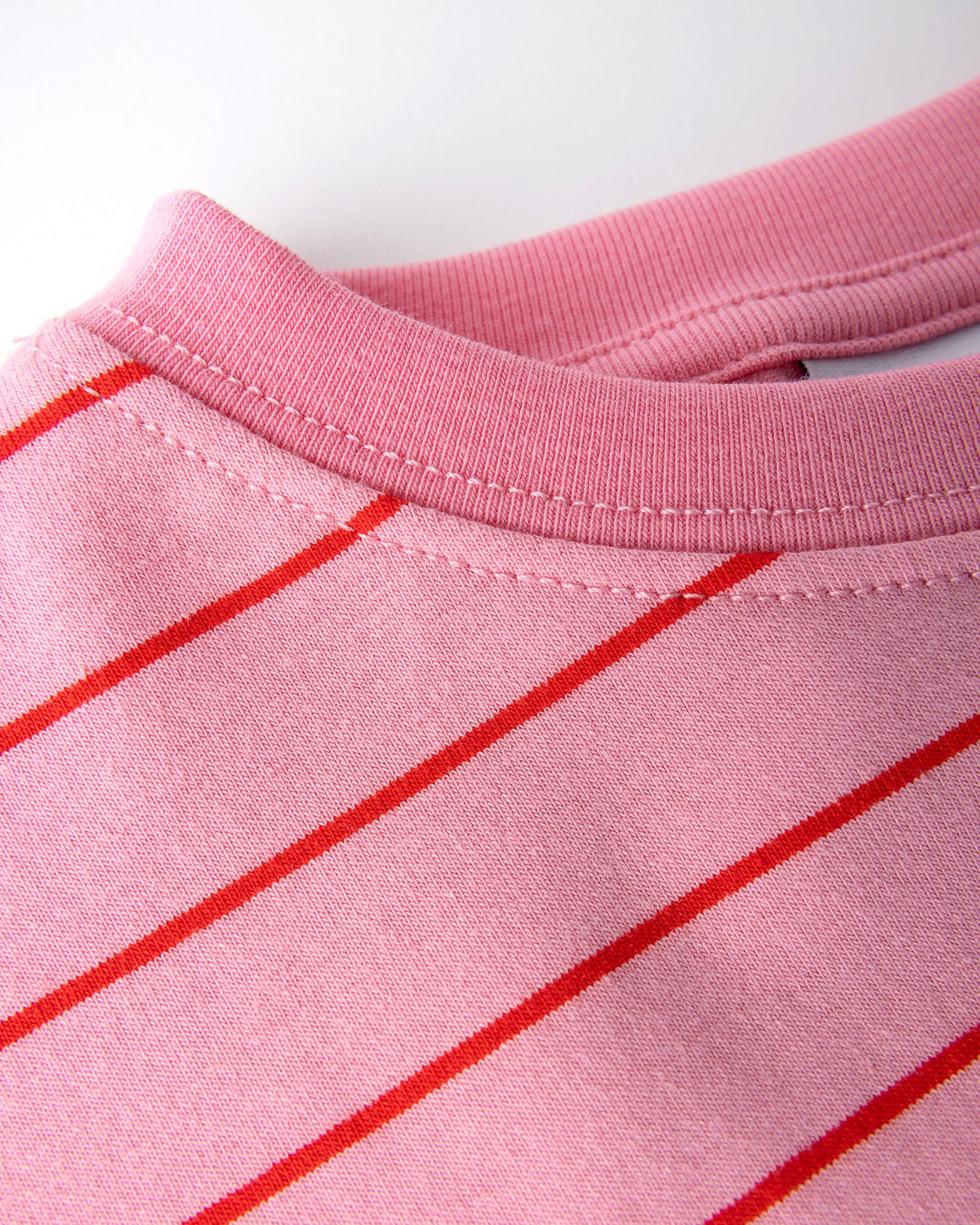 Close up detail of the Happy Rainbow Tee in pink and red stripe