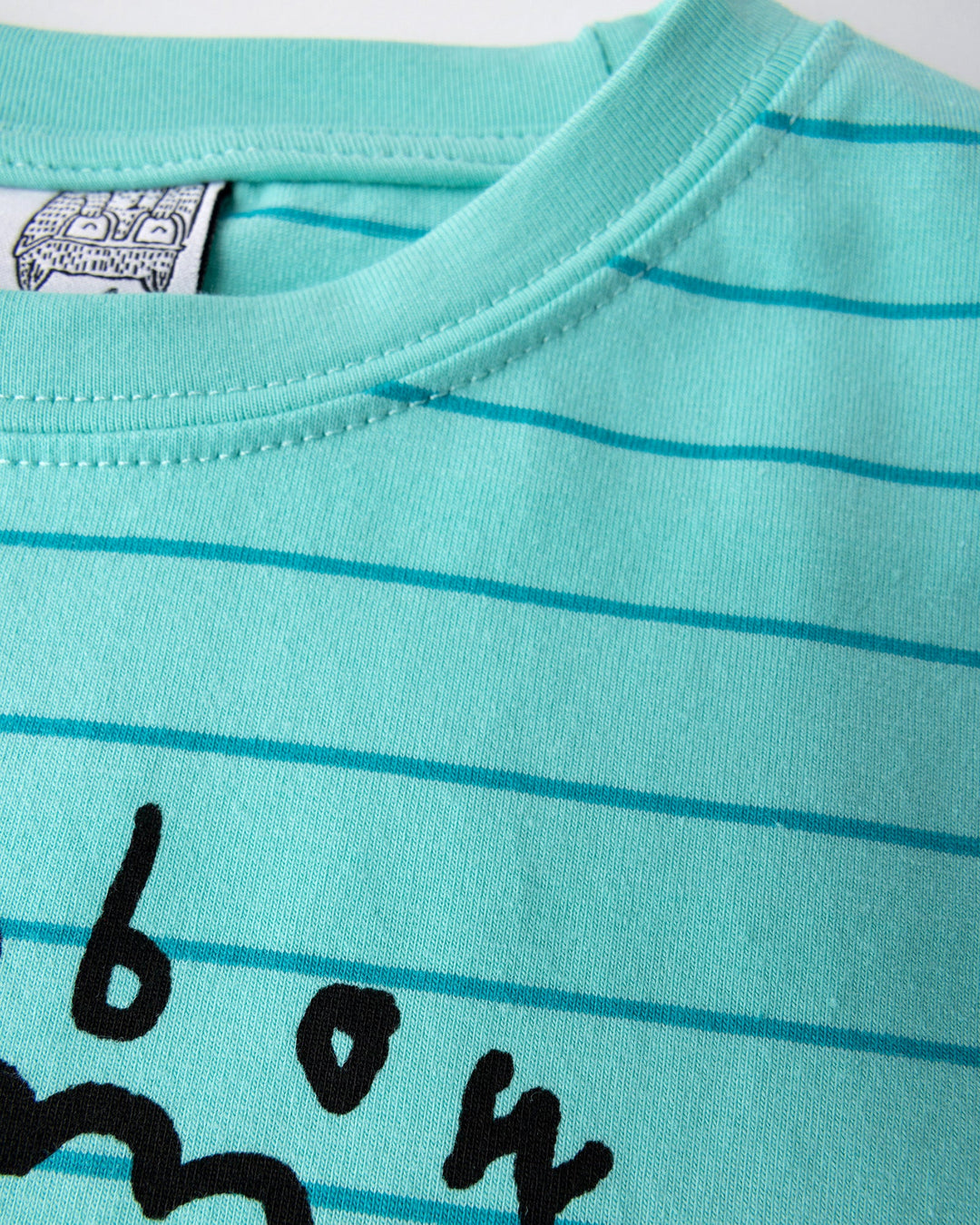 Close up detail of the Happy Rainbow Tee in teal stripe