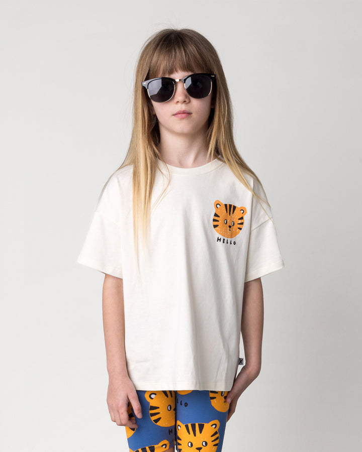 Close up of the Hello Tiger Tee in cream on a kid, front view