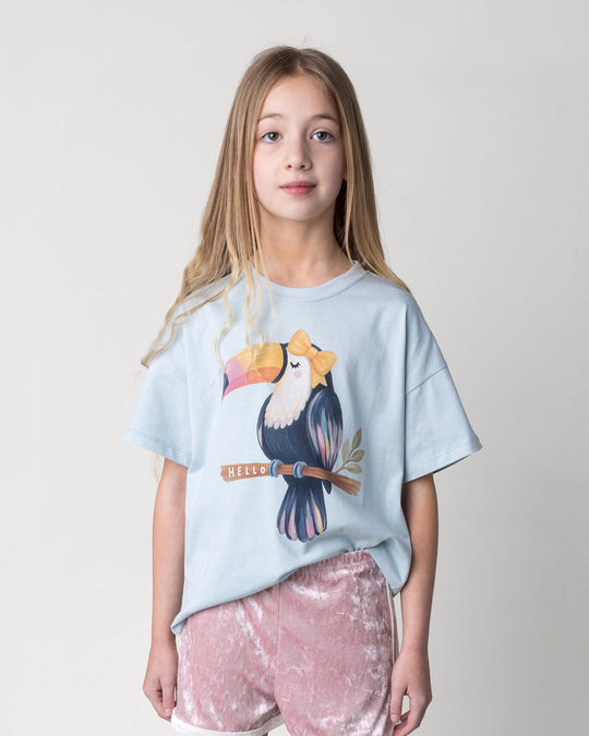 Close up of the Hello Toucan Tee in light blue on a kid, front view