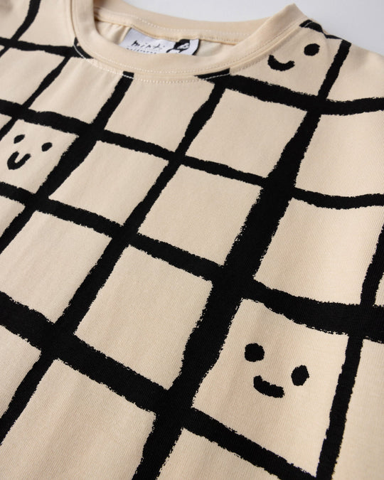 Close up of the Happy Squares Tee print in beige