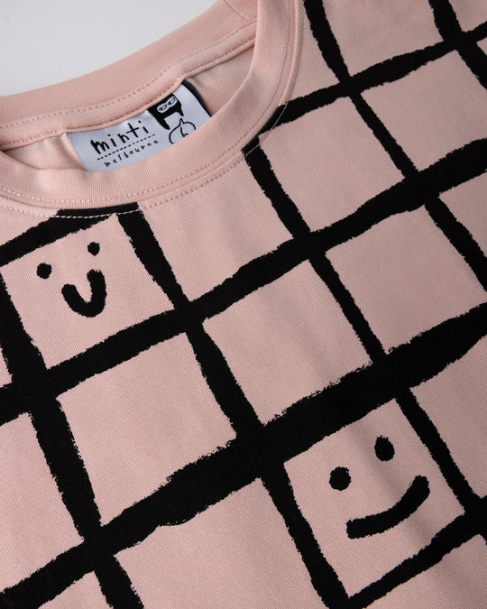 Close up detail of the Happy Squares Tee in dusty pink
