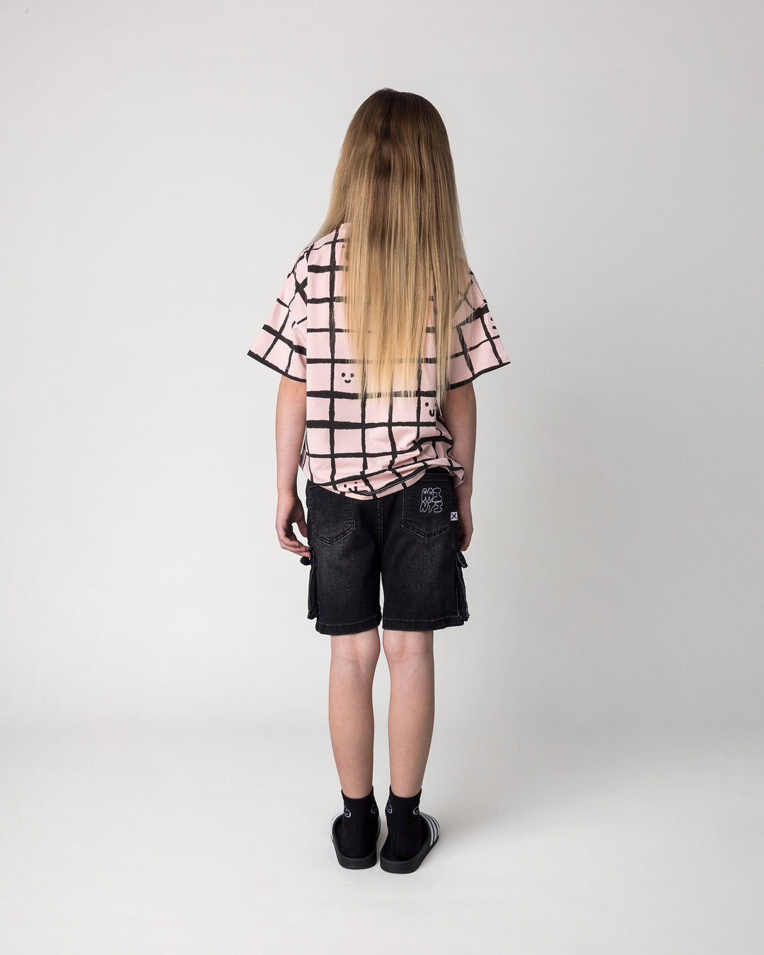 Kid wearing the Happy Squares Tee in dusty pink, back view