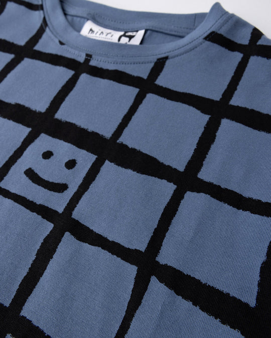 Close up detail of the Happy Squares Tee in muted blue