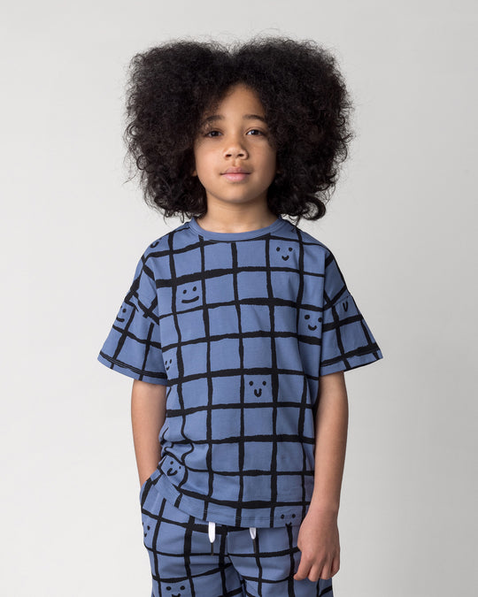 Close up of the Happy Squares Tee in muted blue on a kid, front view