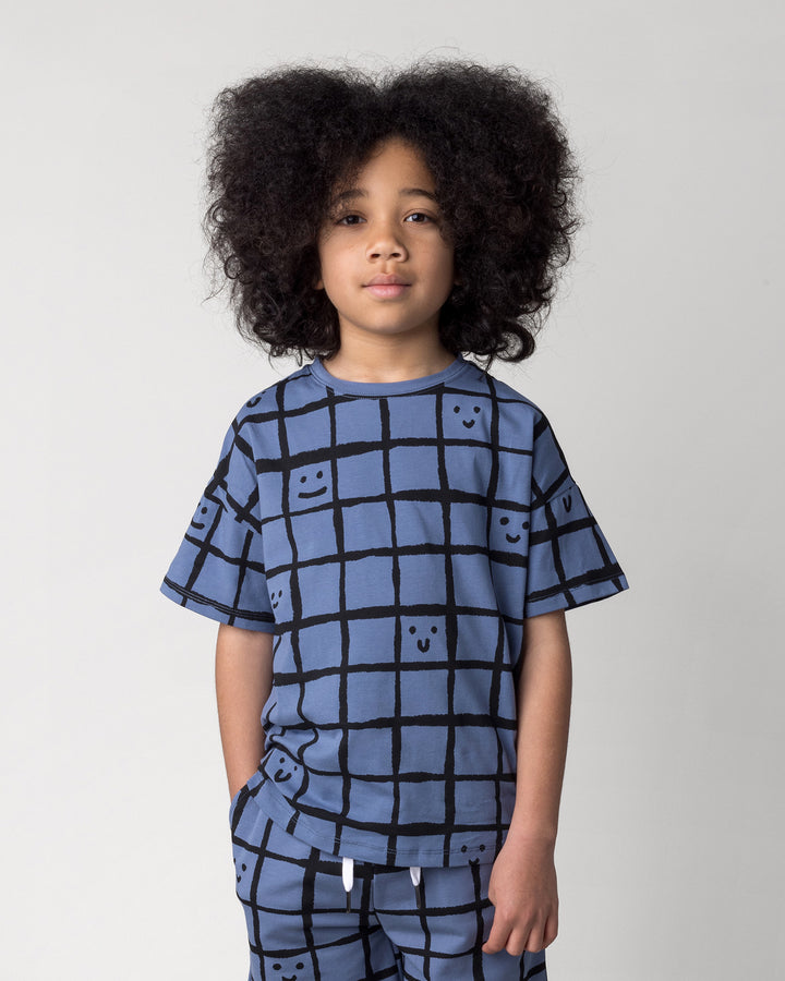 Close up of the Happy Squares Tee in muted blue on a kid, front view