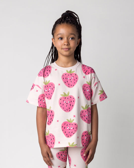 Close up of the Happy Strawberry Tee in cream on a kid, front view