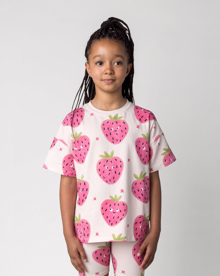 Close up of the Happy Strawberry Tee in cream on a kid, front view