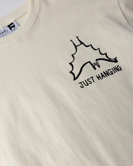 Close up of the Just Hanging Tee print in cream