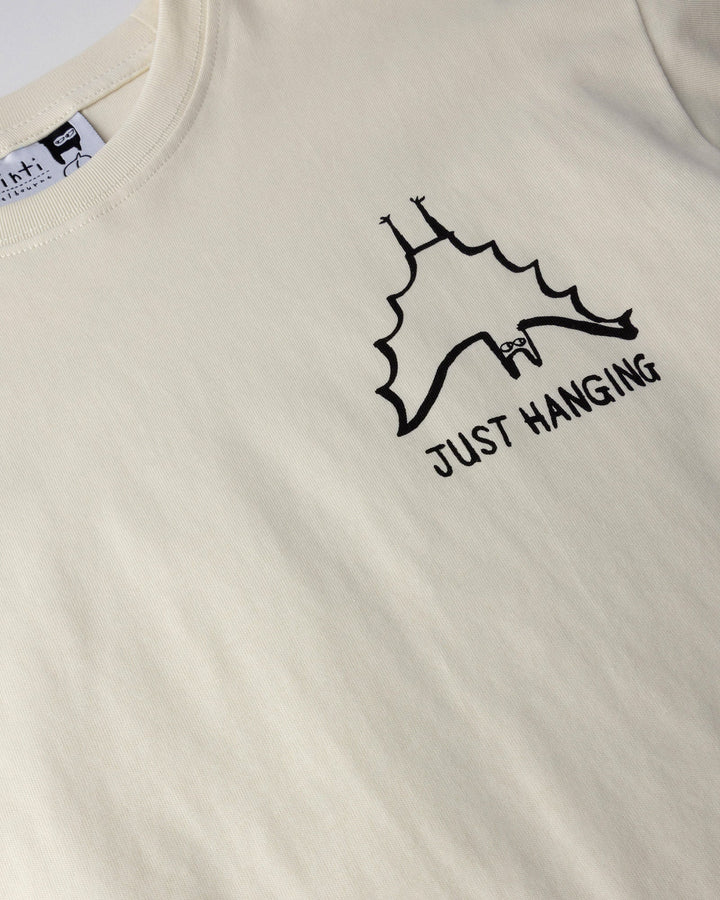 Close up of the Just Hanging Tee print in cream