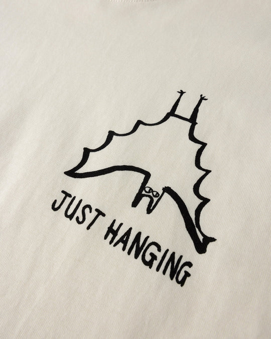 Close up of the Just Hanging Tee print in cream