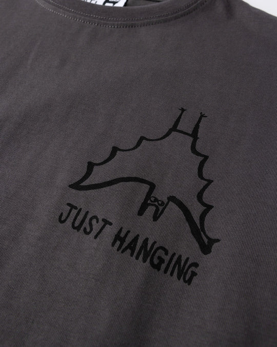 Close up of the Just Hanging Tee print in dark grey