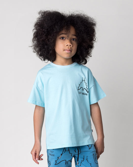 Close up of the Just Hanging Tee in light aqua on a kid, front view