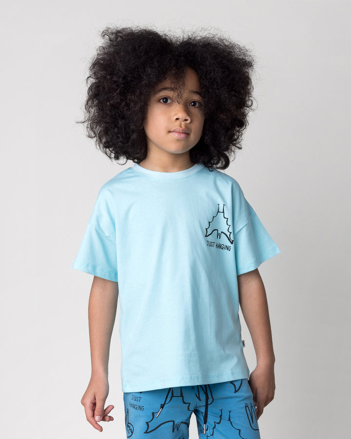 Close up of the Just Hanging Tee in light aqua on a kid, front view